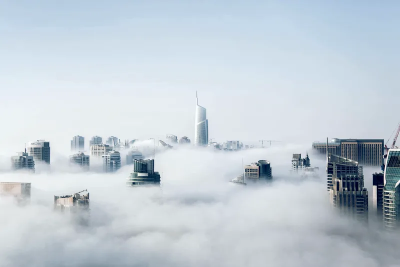 White clouds and blue sky above a tower