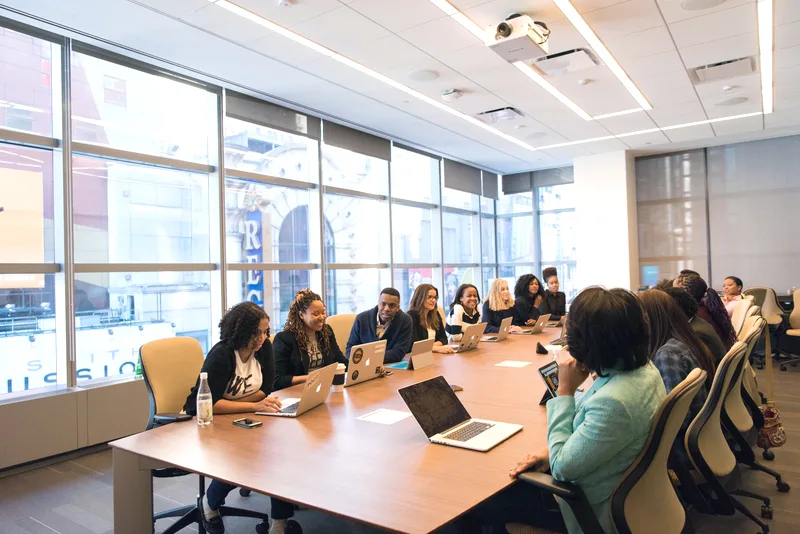A working session in a city office — daylight, notes on the table