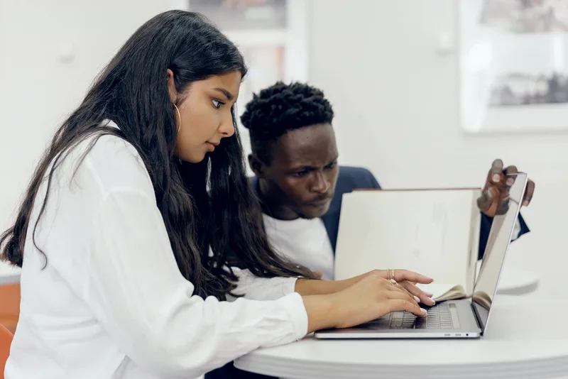 Students collaborating on a laptop